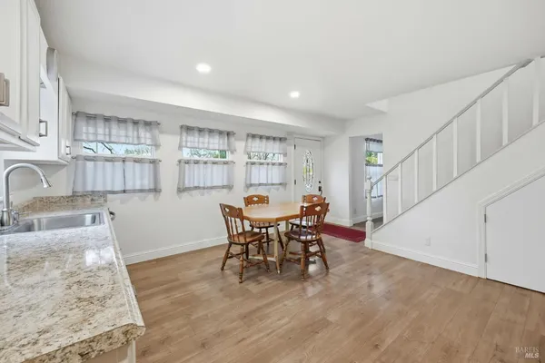a view of a dining room with furniture and wooden floor