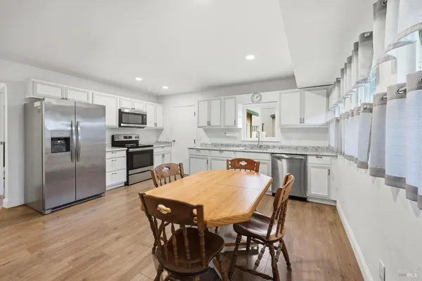 a kitchen with kitchen island a refrigerator stove microwave and cabinets