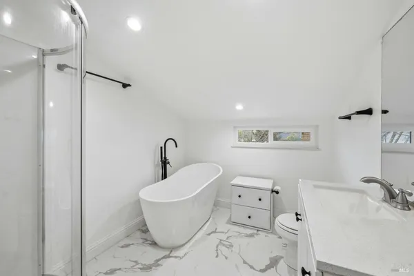 a bathroom with a bathtub and a shower