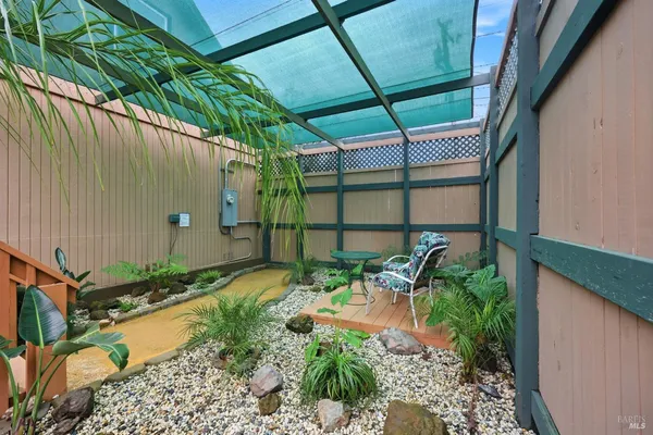 a view of a backyard with sitting area