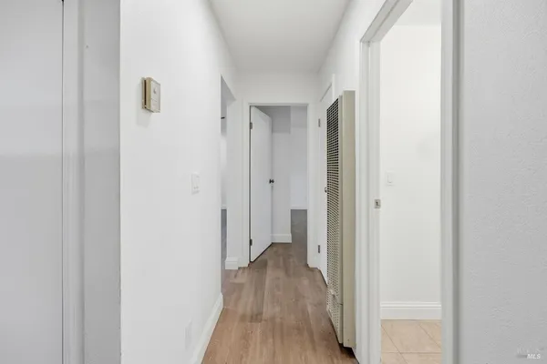a view of a hallway with wooden floor