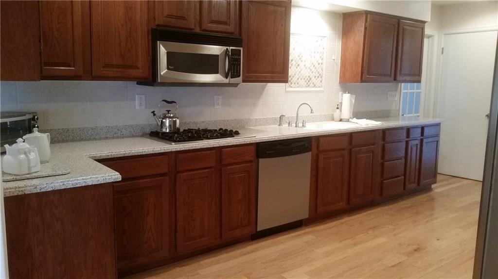 2321 Haymaker Road Monroeville, PA 15146 - Photo 3 of 25 The Chef in the home will love this Gorgeous Kitchen! Hardwood flooring, stainless steel appliances, and Corian Counters and Back splash!