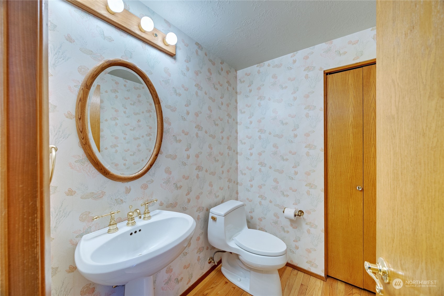 924 Shore Drive Bremerton, WA 98310 - Photo 17 of 36 a bathroom with a toilet sink and mirror