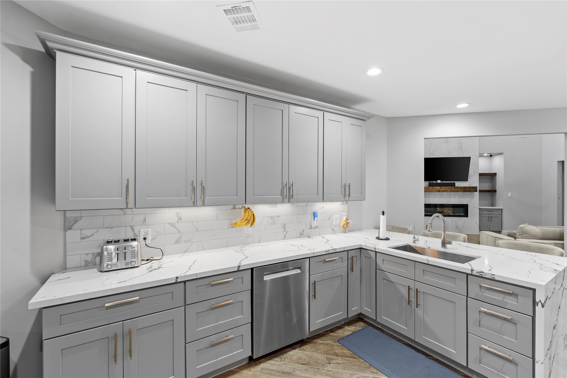 6207 Graff Net Court Spring, TX 77379 - Photo 22 of 49 Marble kitchen countertops with a large sink overlooking the living room.