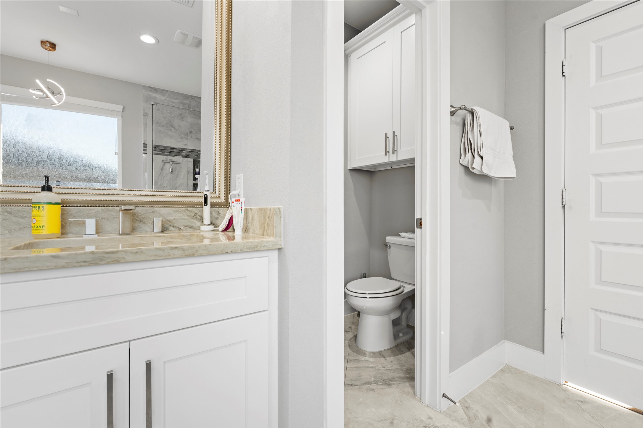 6207 Graff Net Court Spring, TX 77379 - Photo 26 of 49 Functional toilet area with built-in cabinetry for added organization.