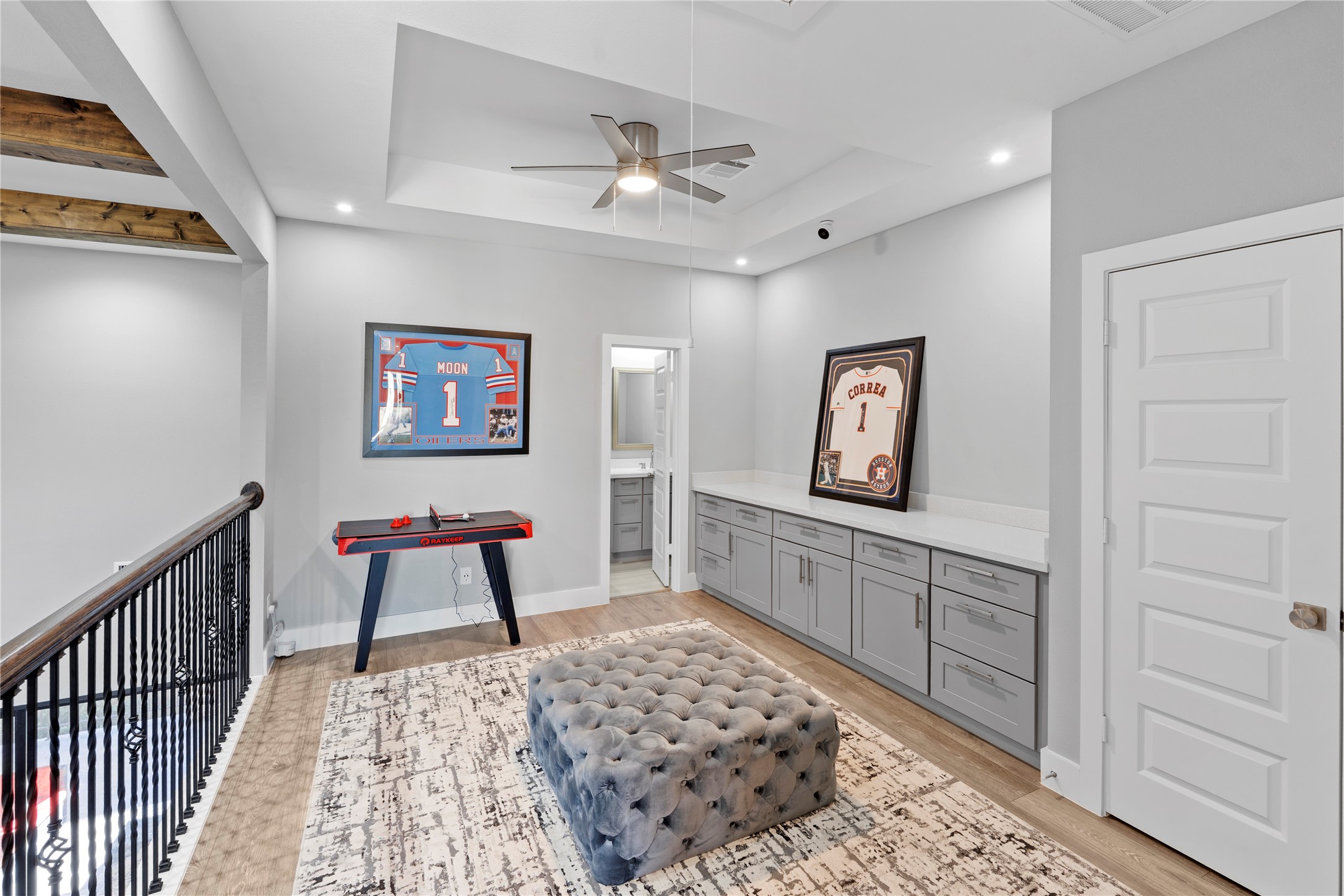 6207 Graff Net Court Spring, TX 77379 - Photo 33 of 49 Bright and stylish upstairs game room featuring built-ins and a tray ceiling, designed for fun and functionality!