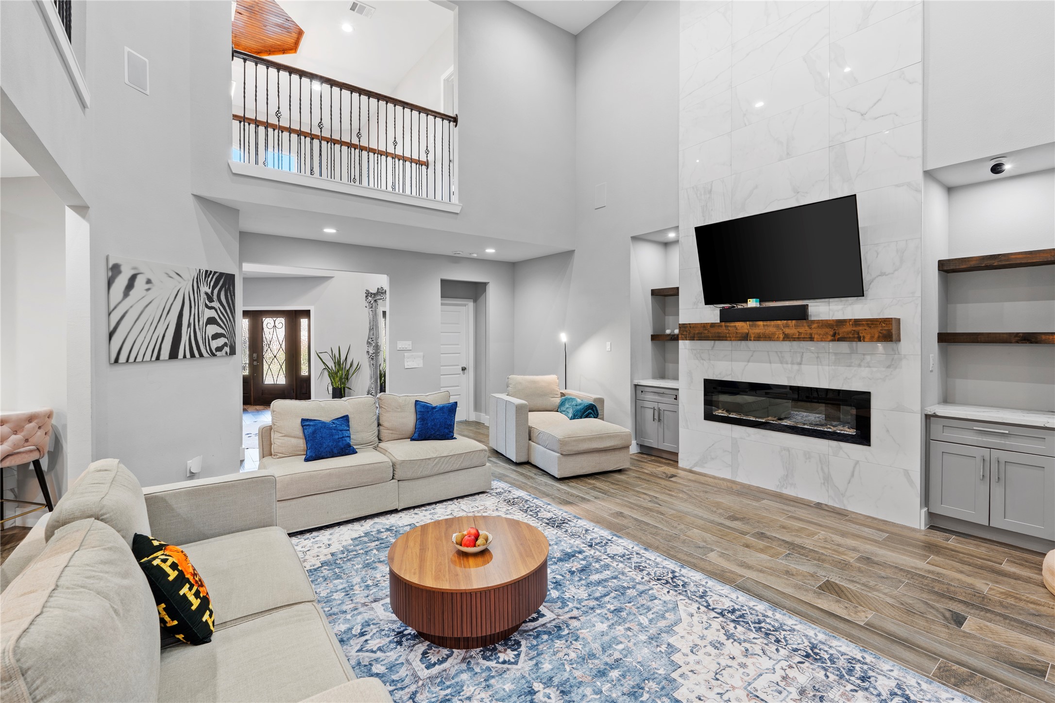 6207 Graff Net Court Spring, TX 77379 - Photo 4 of 49 Expansive living room with elegant built-ins and an electric fireplace, offering warmth and style.