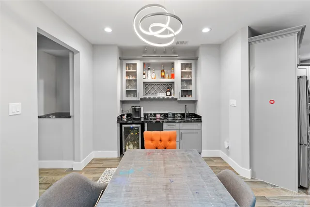 a view of kitchen with stainless steel appliances granite countertop a stove and a refrigerator