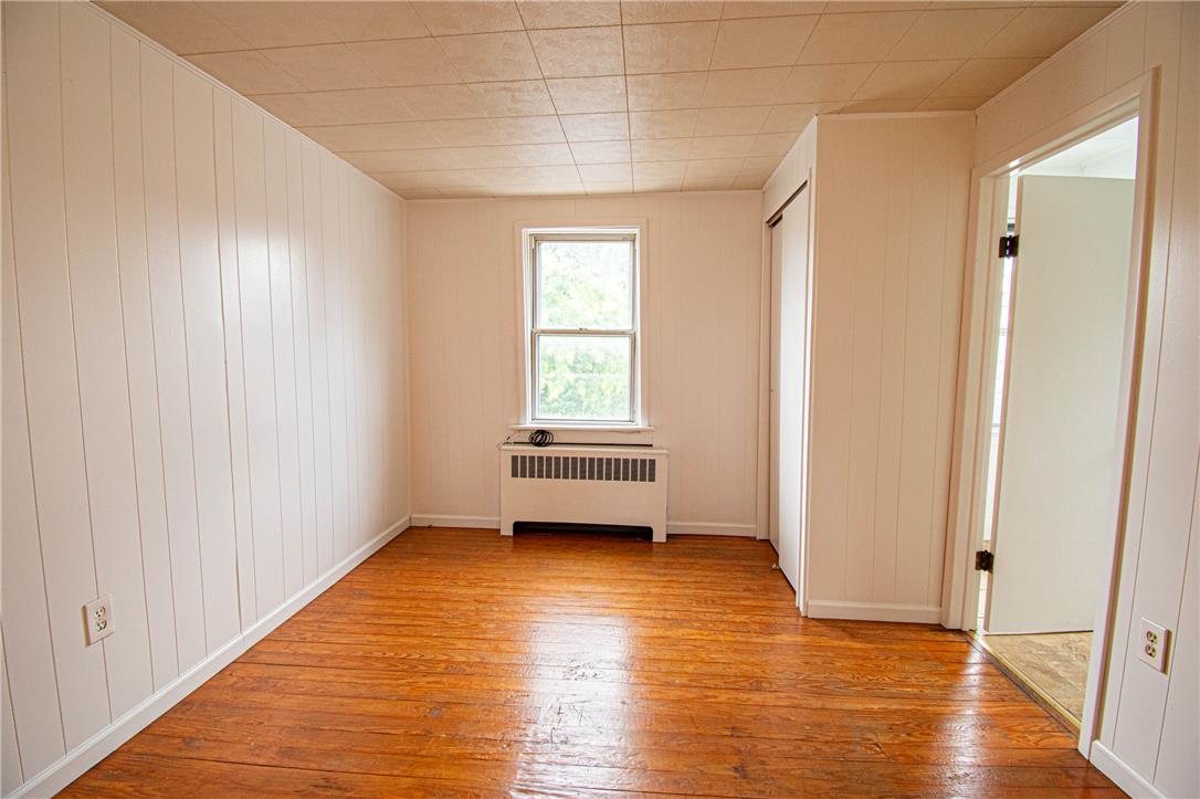 27 West Allen Street Allentown, PA 18102 - Photo 14 of 26 A well-lit bedroom features classic hardwood floors and a single window.