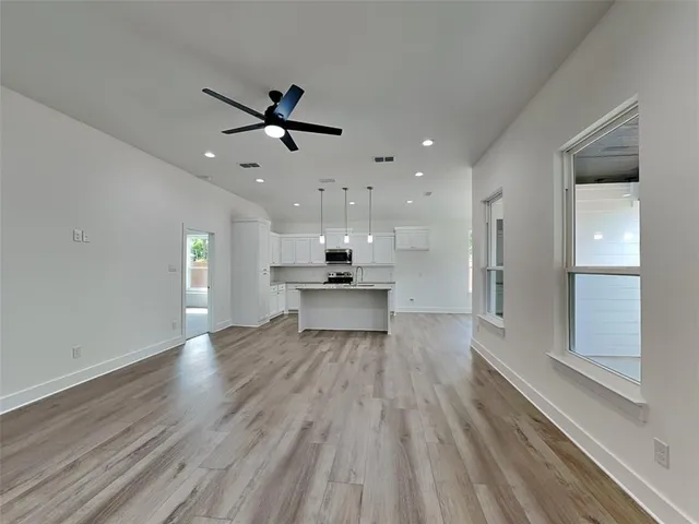a view of a kitchen with wooden floor and a kitchen