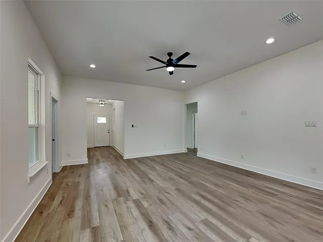 wooden floor in an empty room with a window