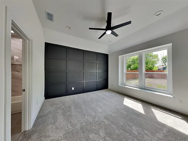 a view of a livingroom with a ceiling fan and window