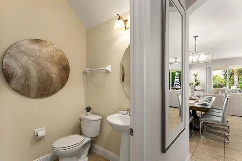 a bathroom with a toilet and a mirror