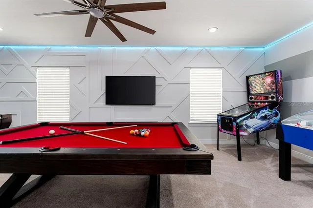 a room with pool table and flat screen tv