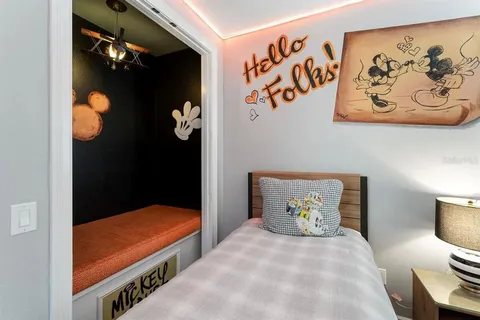 a bedroom with a bed and lamp