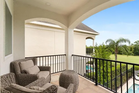 a balcony with furniture and a window