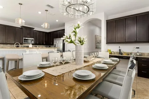 a kitchen with a table and chairs in it