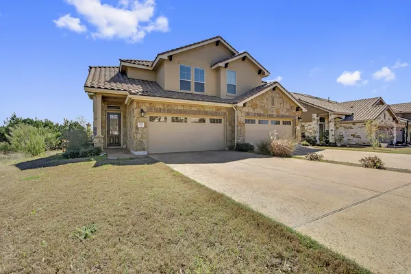 a front view of a house with a yard and garage
