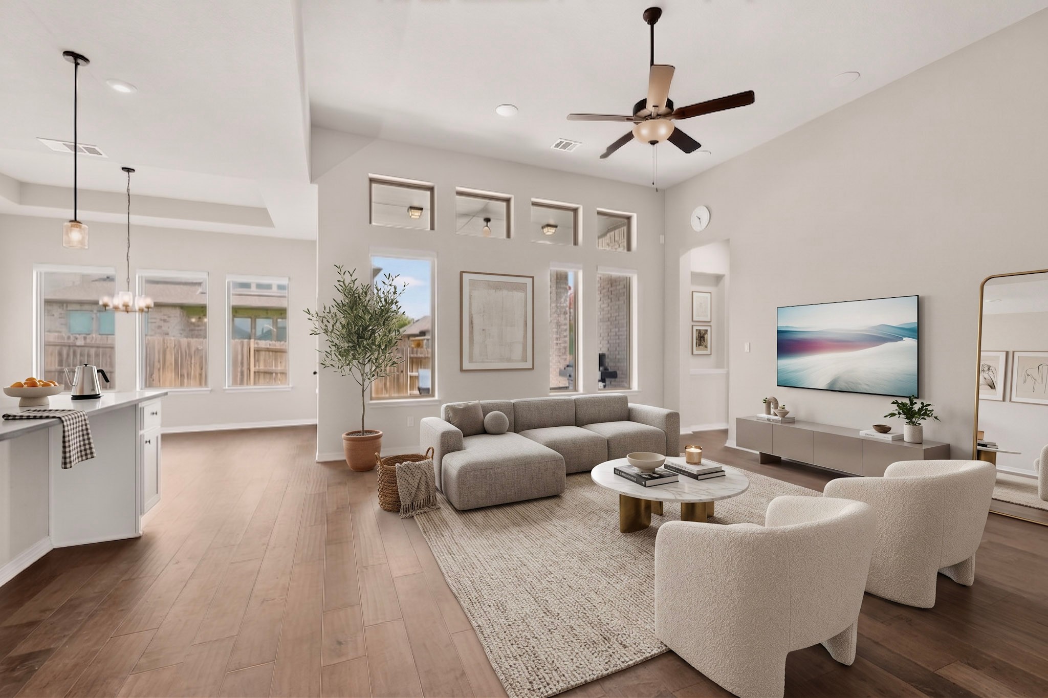 2433 La Mirada Street Leander, TX 78641 - Photo 5 of 25 Natural light floods this inviting living space, highlighting the rich hardwood flooring and high ceilings.