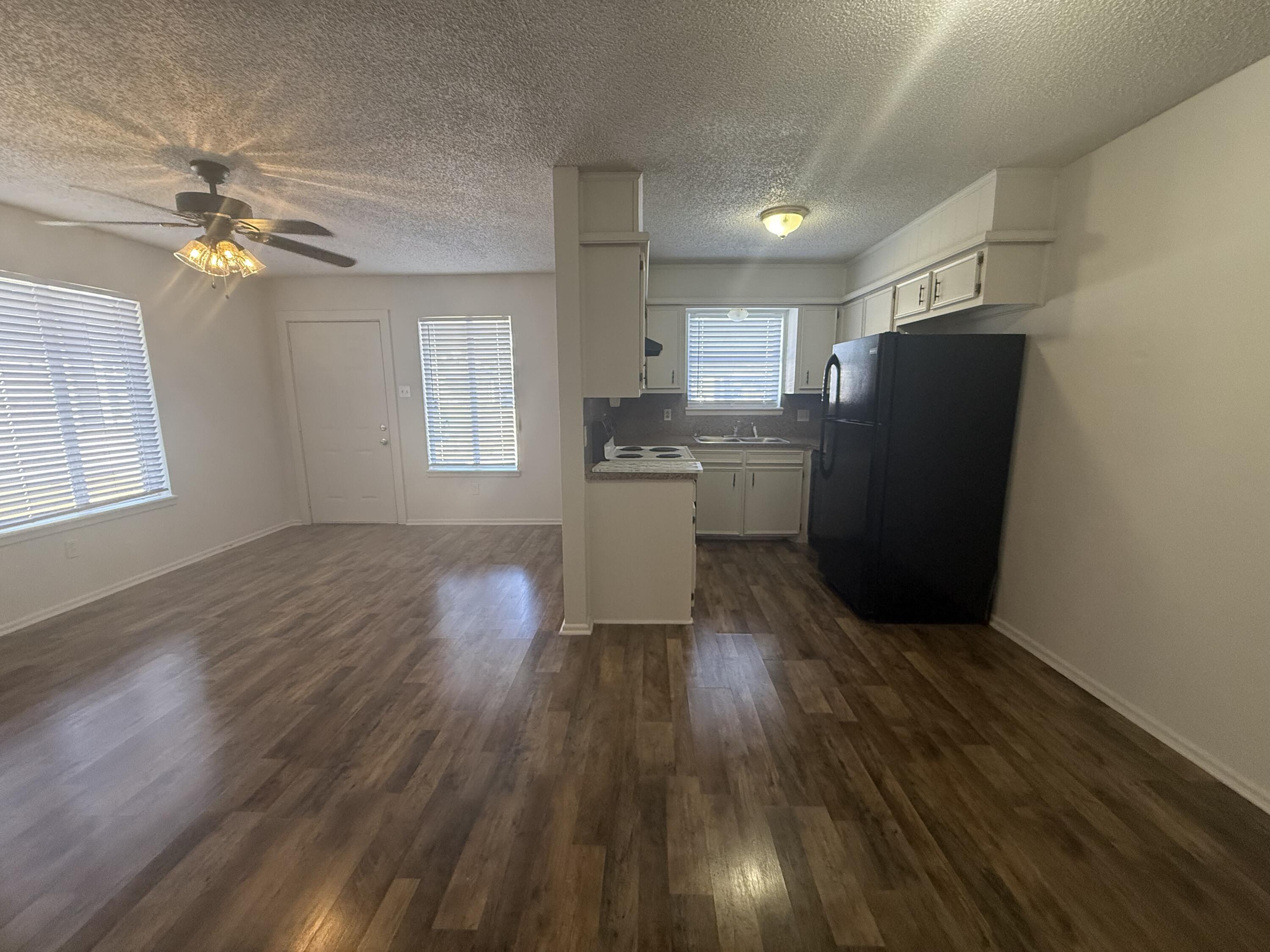 2317 15th Street Lubbock, TX 79401 - Photo 3 of 8 a living room with stainless steel appliances wooden floors