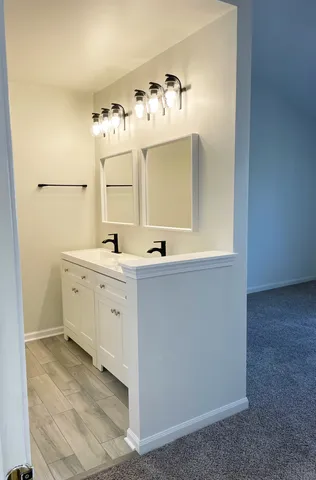 a bathroom with a sink vanity and mirror