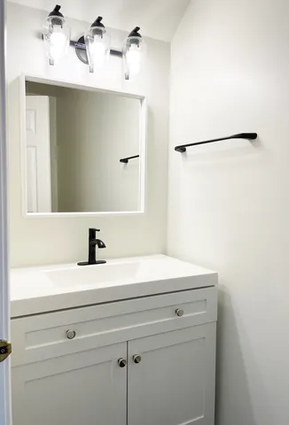 a bathroom with a sink and a mirror