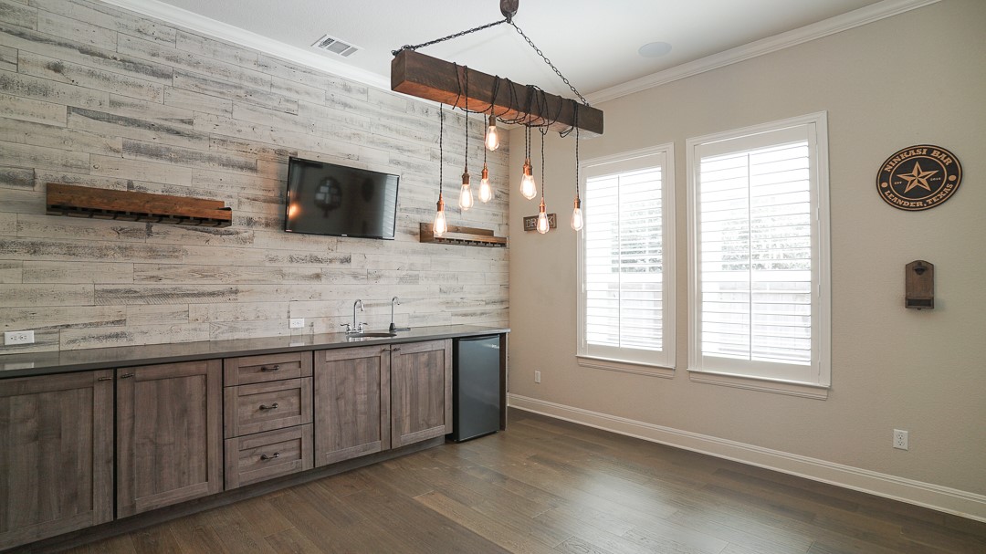 629 Germander Road Leander, TX 78641 - Photo 5 of 32 A refined dry bar with rustic wood paneling offers both style and utility, perfect for entertaining.
