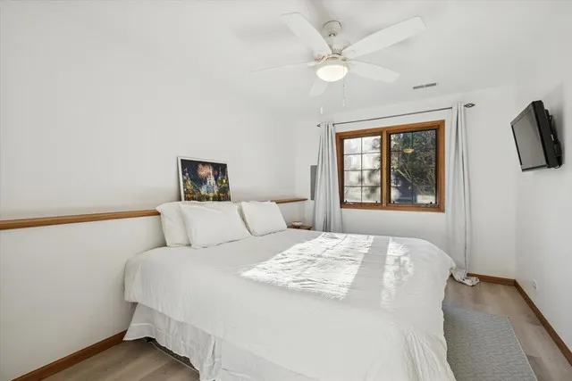 a bedroom with a large bed and a window