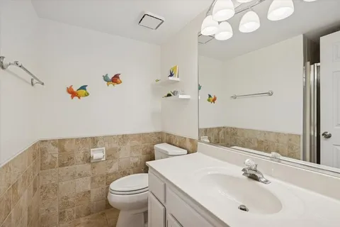 a bathroom with a sink a toilet and a mirror