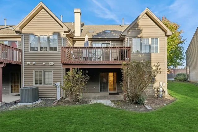 a view of a house with brick walls and a yard with plants