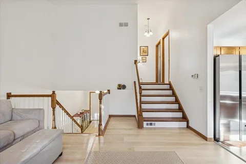 a view of a hallway with staircase and white walls