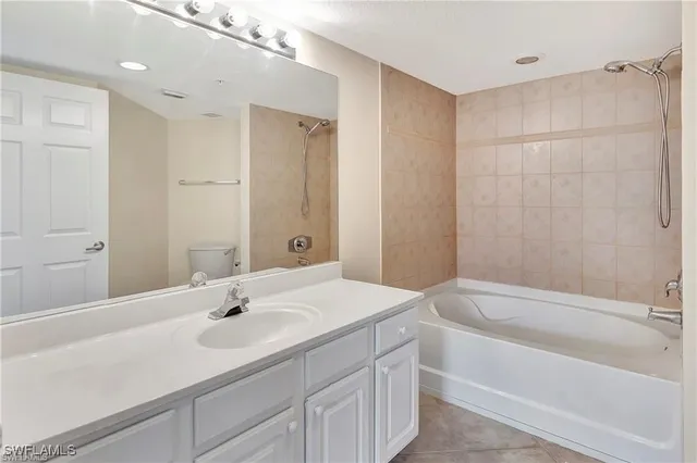 a bathroom with a sink tub vanity and shower