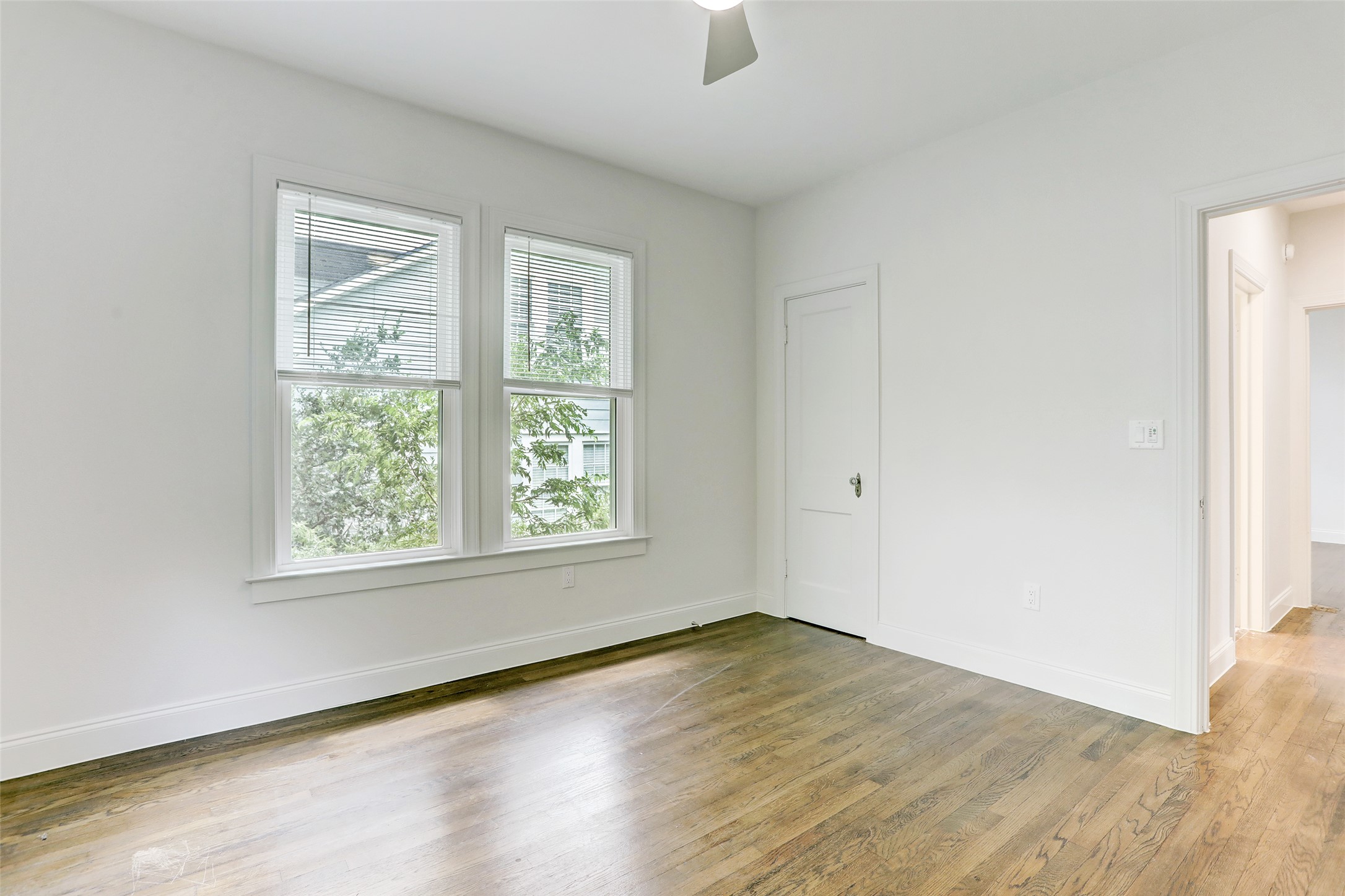 603 Bellevue Place, Unit B Austin, TX 78705 - Photo 12 of 22 an empty room with wooden floor and windows
