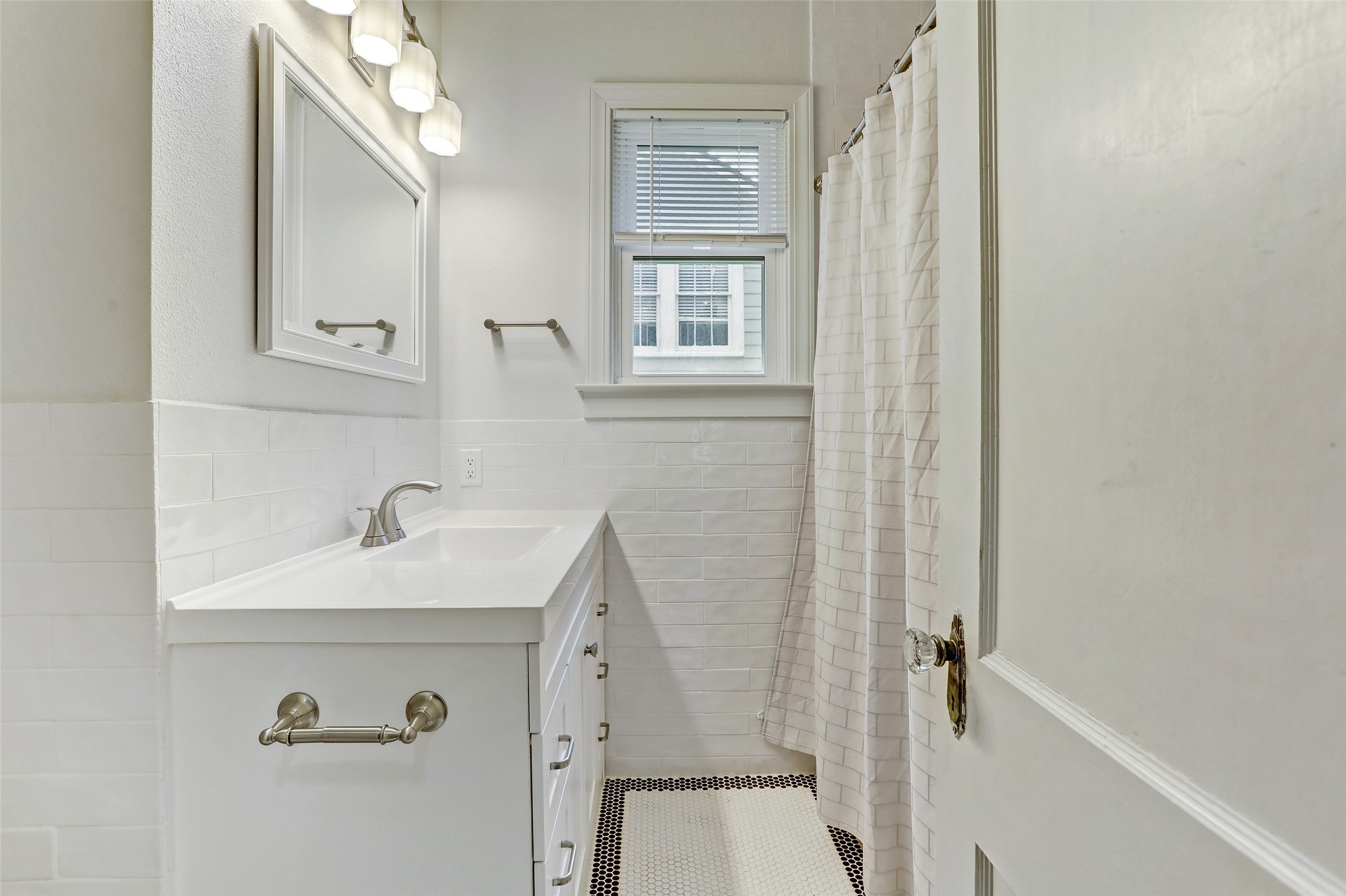 603 Bellevue Place, Unit B Austin, TX 78705 - Photo 13 of 22 a bathroom with a sink and a mirror