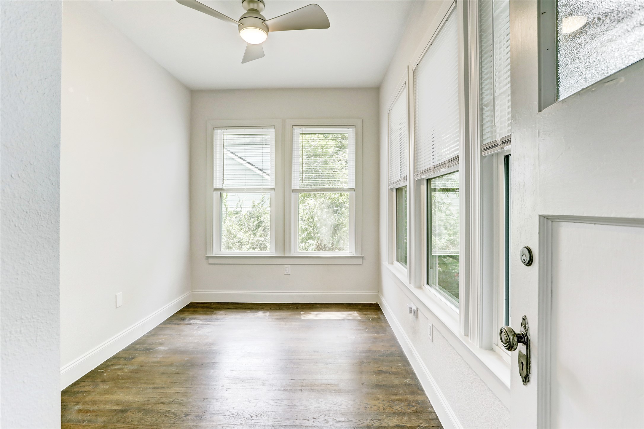 603 Bellevue Place, Unit B Austin, TX 78705 - Photo 14 of 22 an empty room with wooden floor and windows