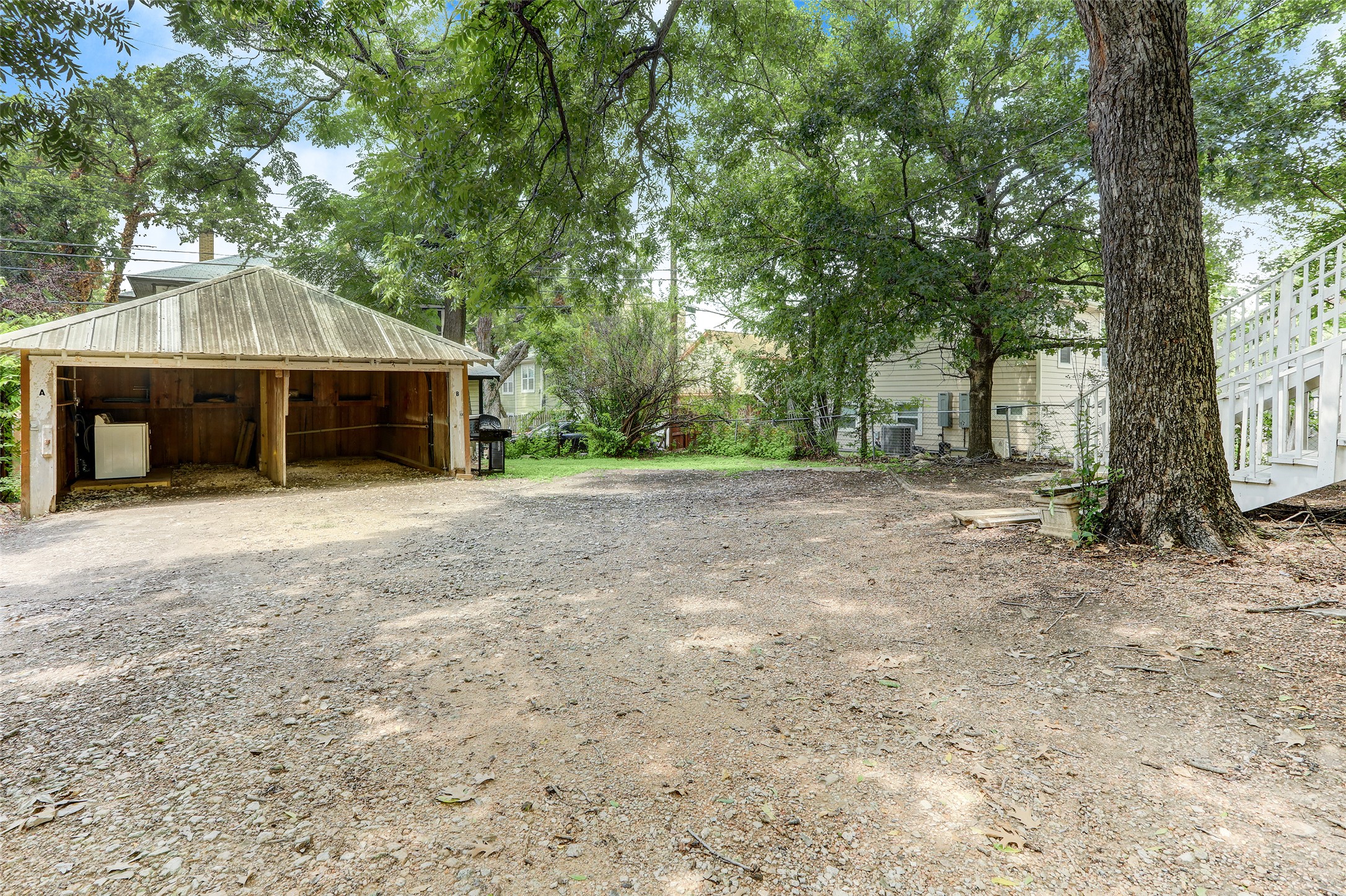 603 Bellevue Place, Unit B Austin, TX 78705 - Photo 17 of 22 a front view of a house with a garden and trees