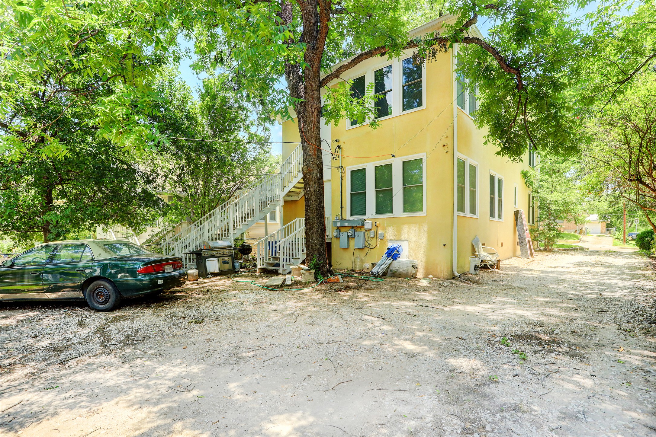 603 Bellevue Place, Unit B Austin, TX 78705 - Photo 18 of 22 a view of a blue house with large trees