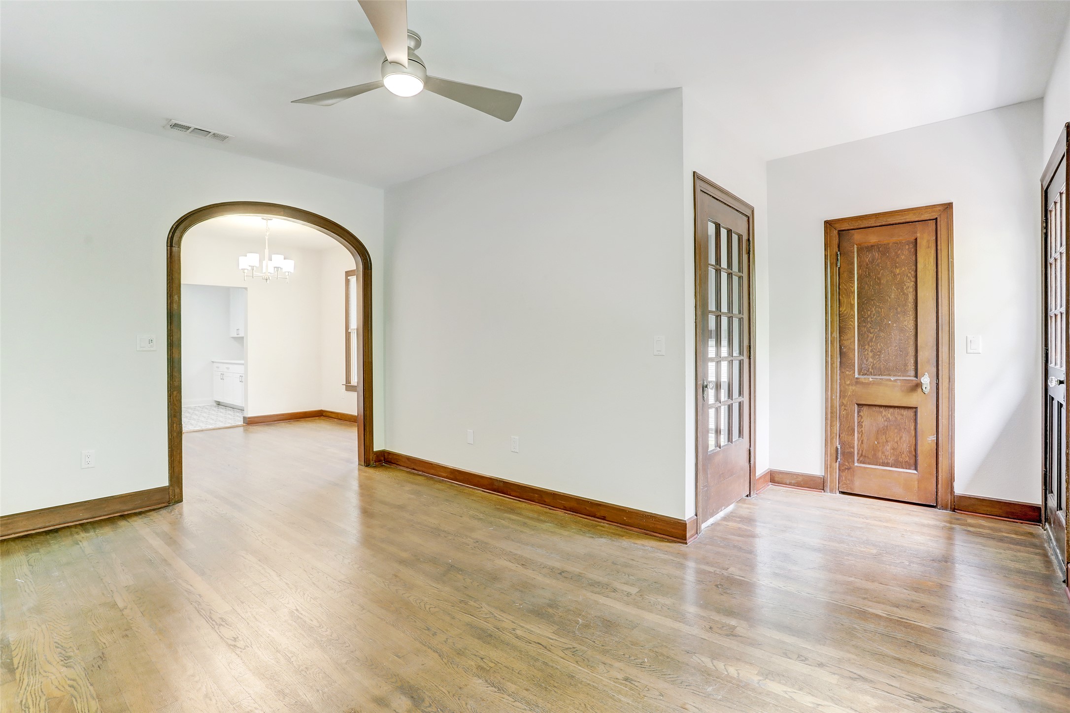 603 Bellevue Place, Unit B Austin, TX 78705 - Photo 2 of 22 an empty room with wooden floor cabinet and windows