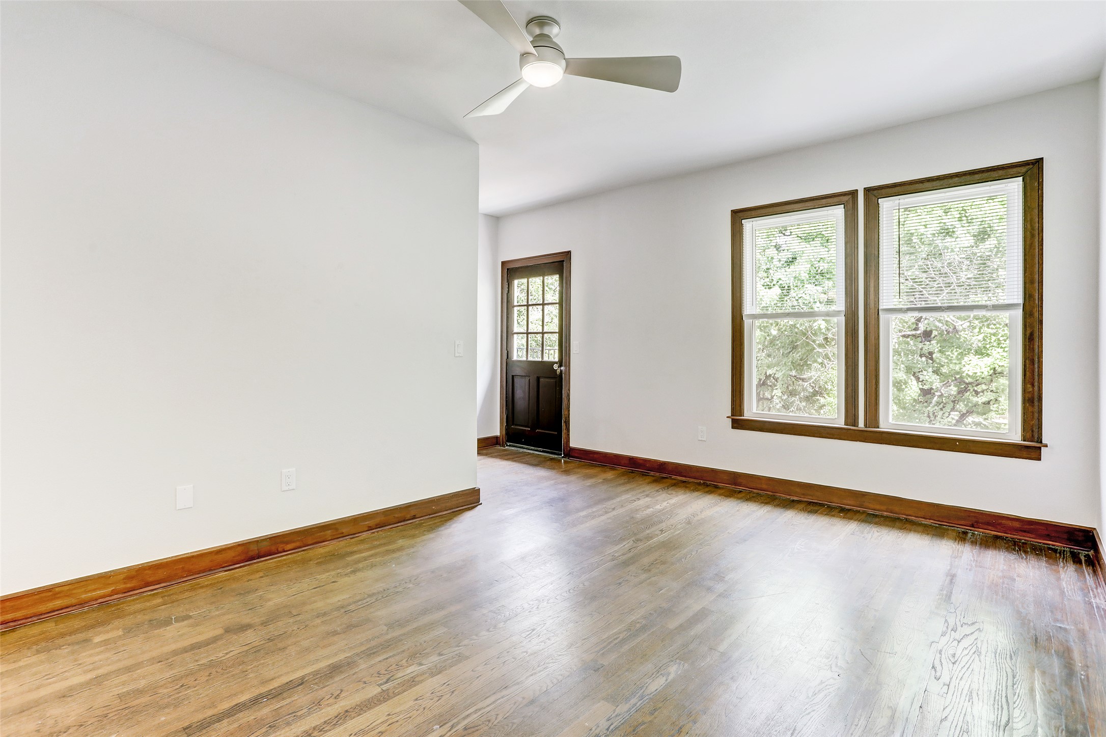 603 Bellevue Place, Unit B Austin, TX 78705 - Photo 3 of 22 an empty room with wooden floor and windows