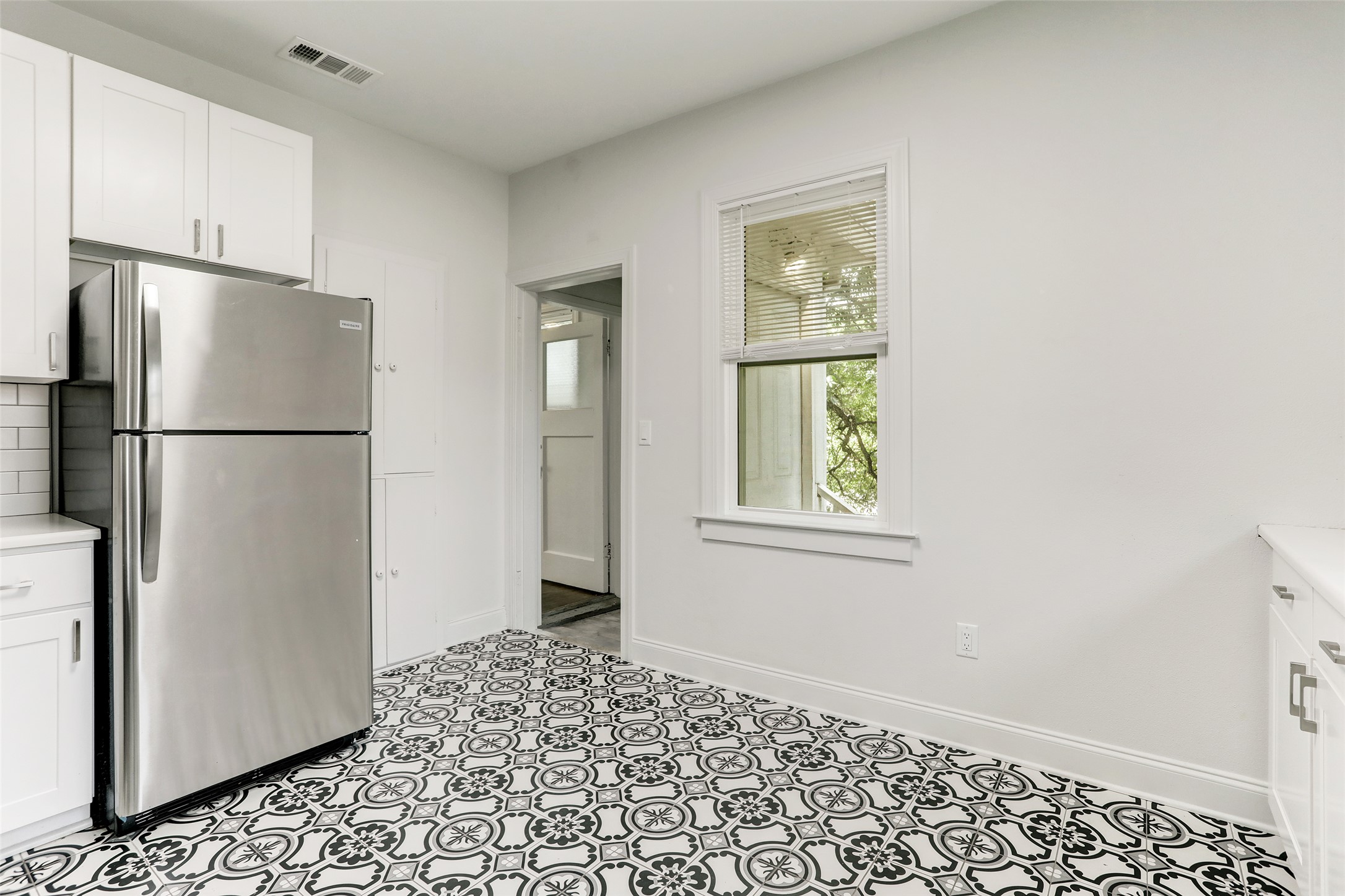 603 Bellevue Place, Unit B Austin, TX 78705 - Photo 6 of 22 a white refrigerator freezer sitting inside of a kitchen