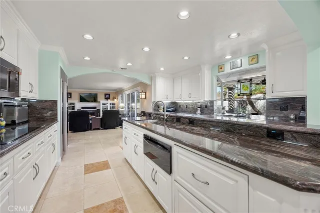 a large kitchen with stainless steel appliances lots of counter top space