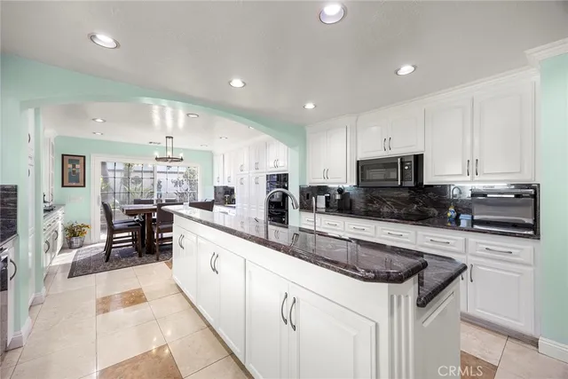 a kitchen with stainless steel appliances granite countertop a refrigerator sink and cabinets