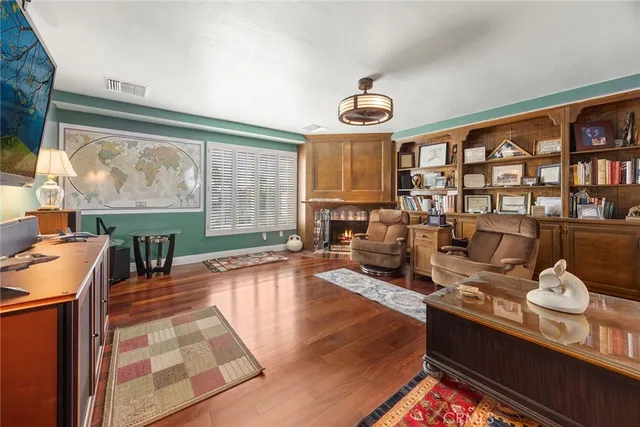 a living room with furniture a fireplace and a floor to ceiling window