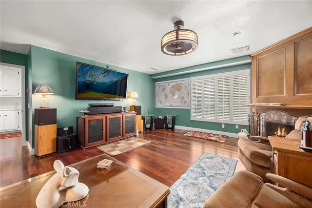 a living room with furniture a flat screen tv and a large window