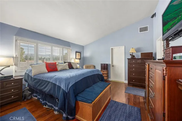 a bed room with a bed and a television