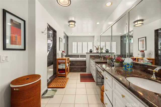 a kitchen with stainless steel appliances granite countertop a sink and dishwasher a refrigerator with wooden cabinets