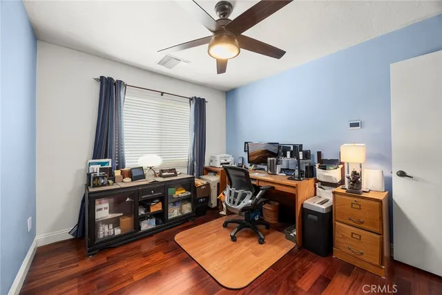 a view of a workspace with furniture and a window