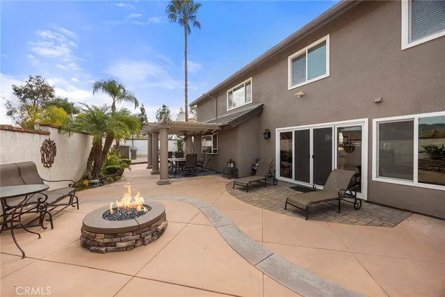 a view of a patio with table and chairs potted plants