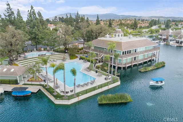 a view of a swimming pool with lawn chairs and a table