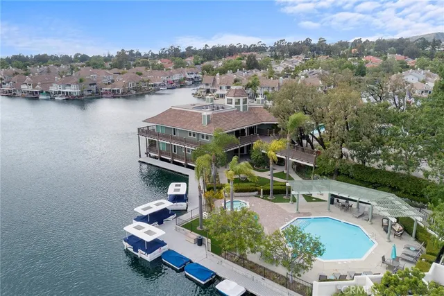 an aerial view of residential houses with outdoor space and river